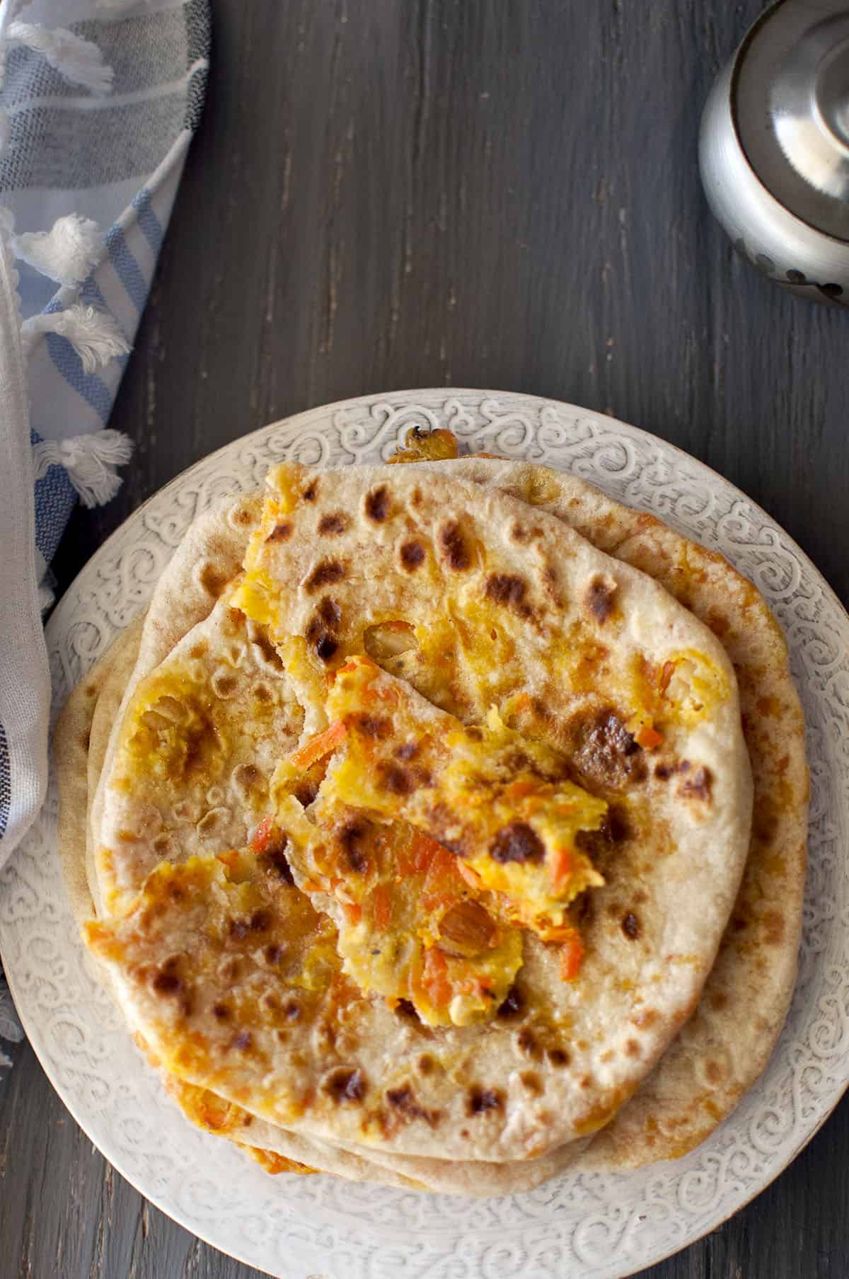 Grey plate with stuffed flatbread with a stuffing showing