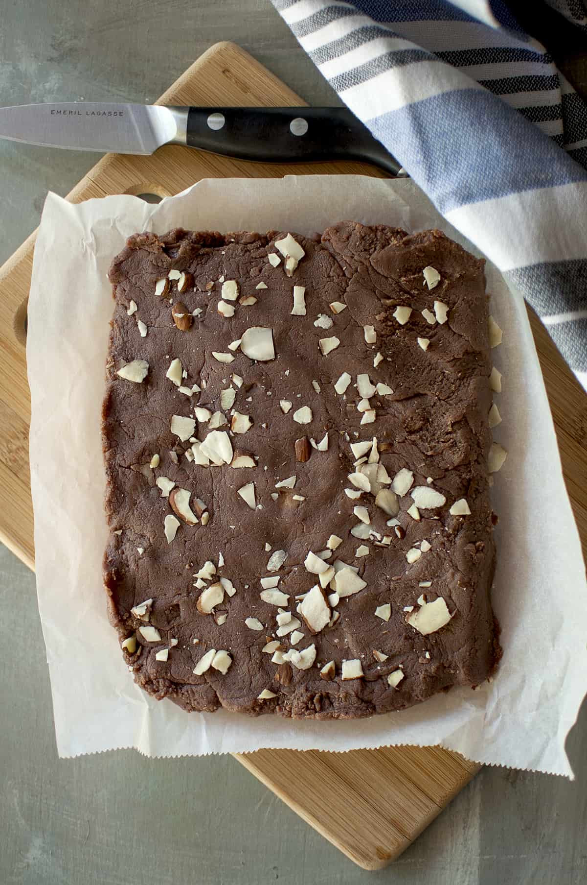 Chopping board with parchment paper with cooked fudge