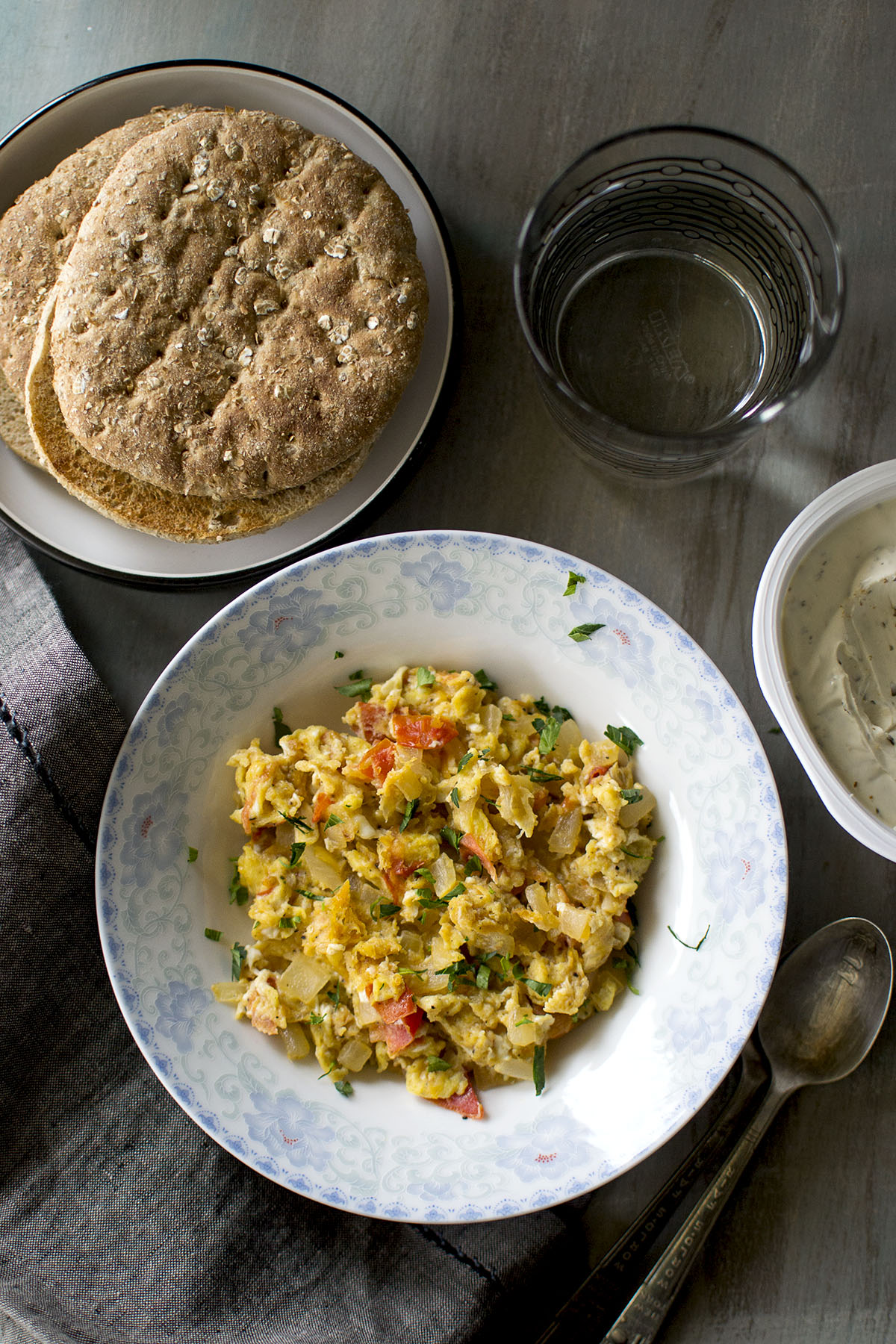 White bowl with scrambled eggs with tomatoes