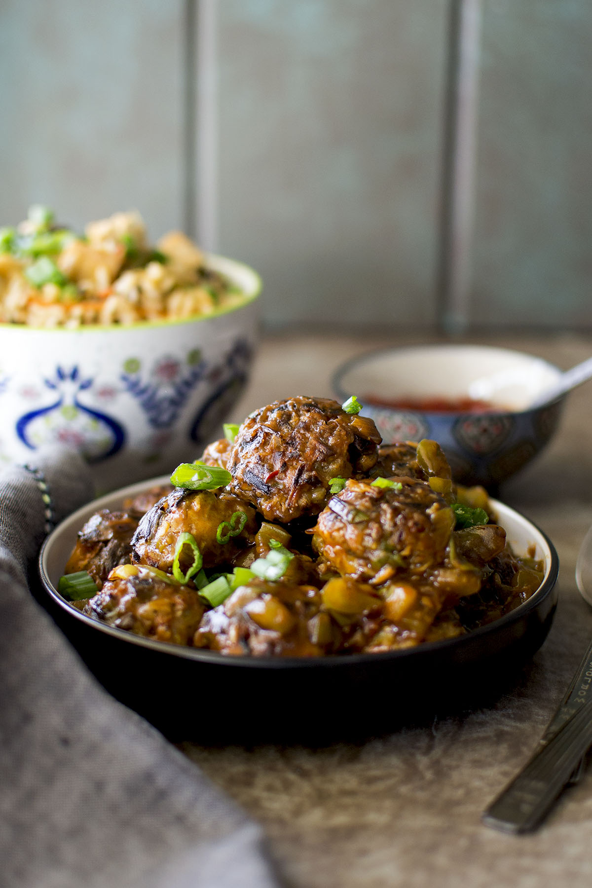 Black plate with a stack of Vegetable Manchurian.