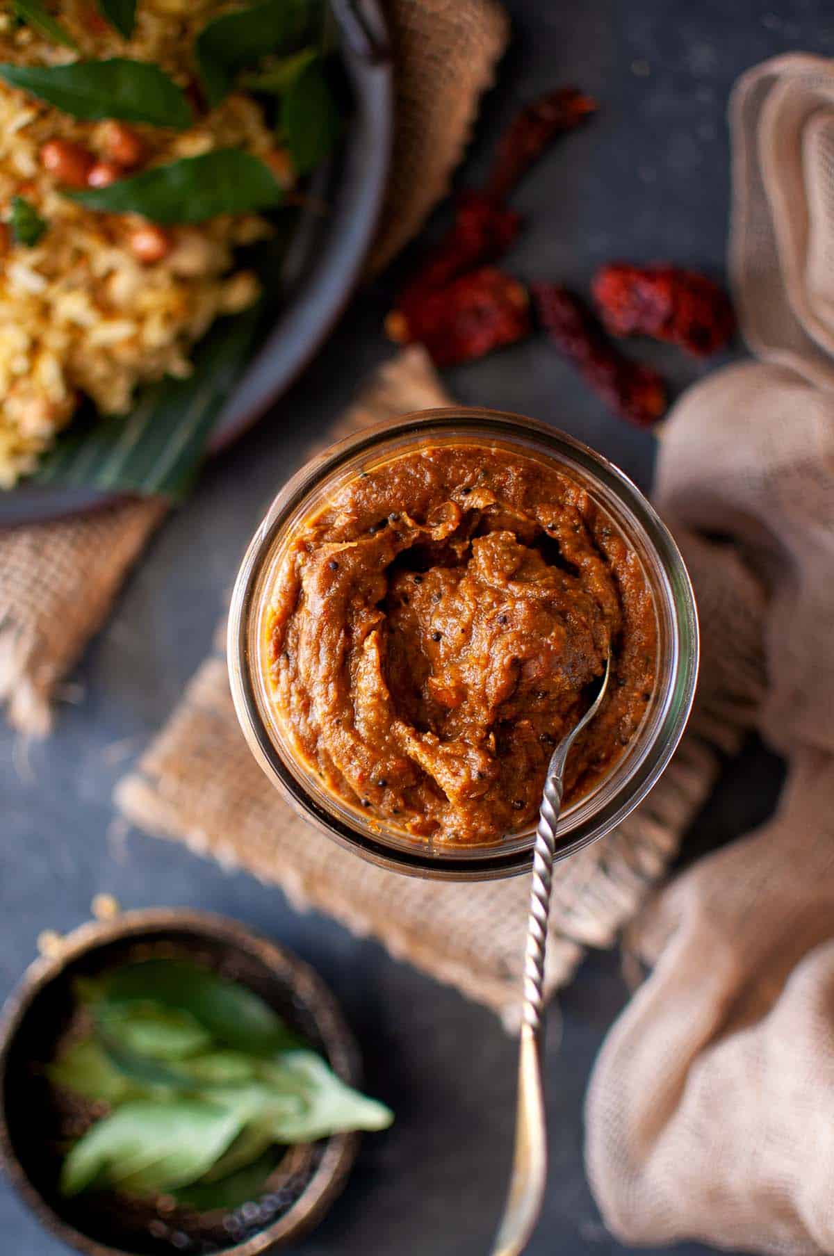 Glass jar with puliyodarai paste.