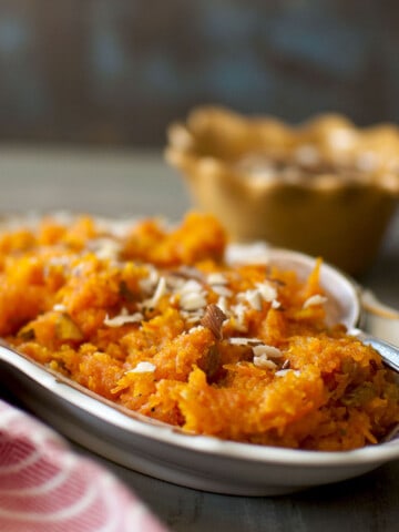 White oval bowl with gajar halwa