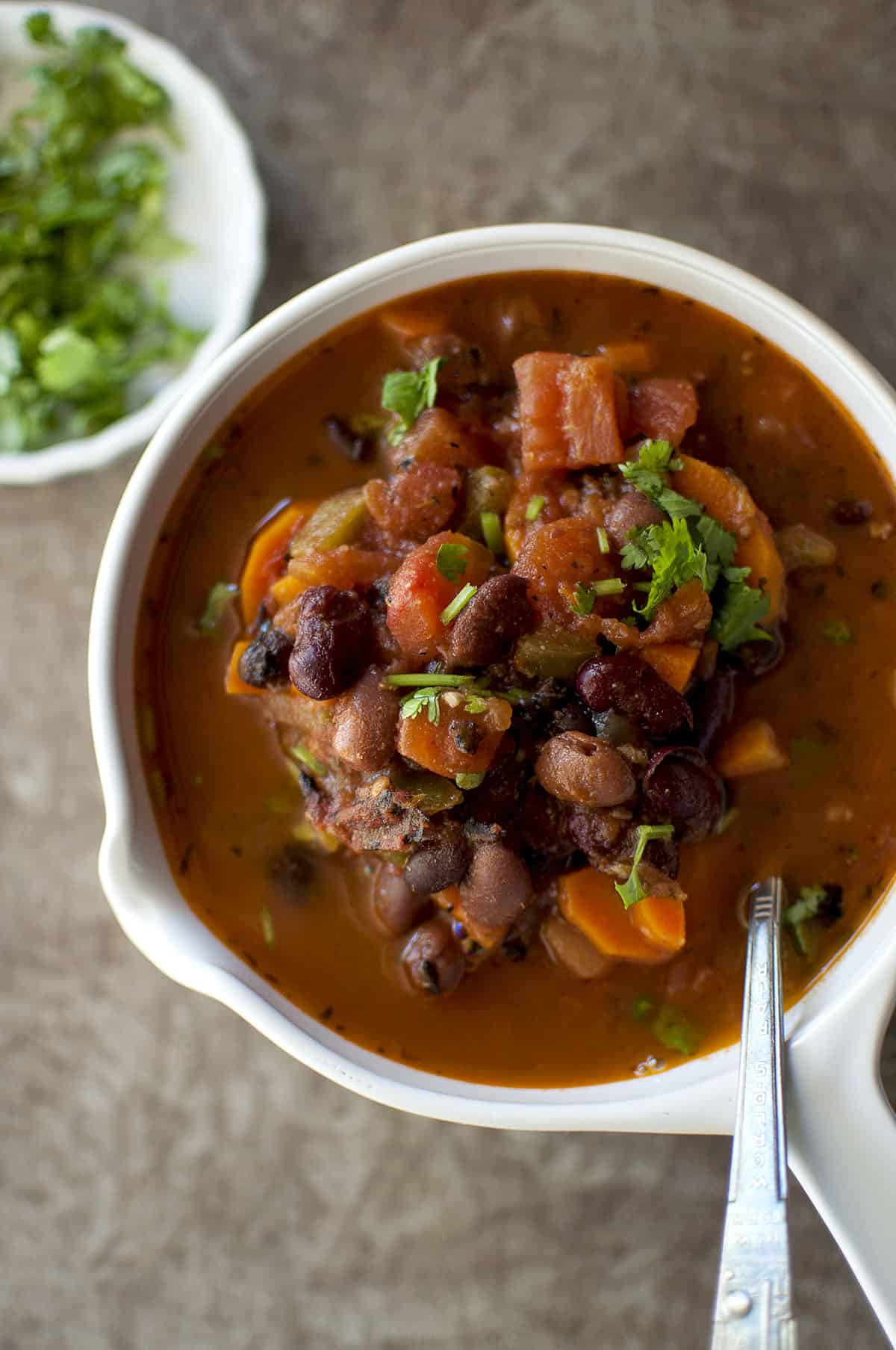 Top view of a white bowl with vegetable bean stew.