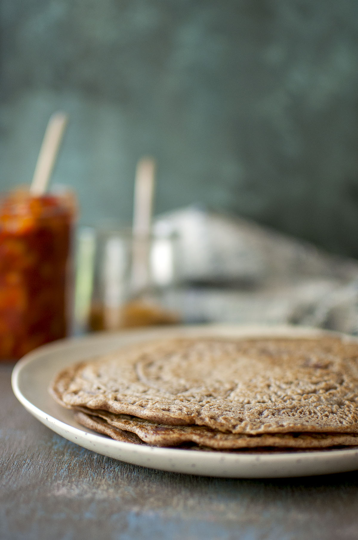 Grey plate with a stack of ragi adai