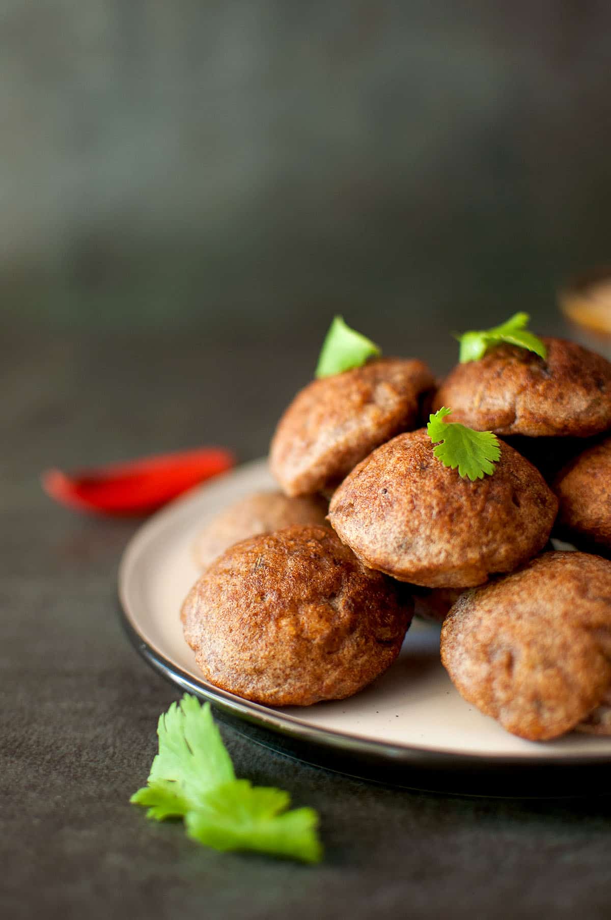 Grey plate with a stack of paddu.