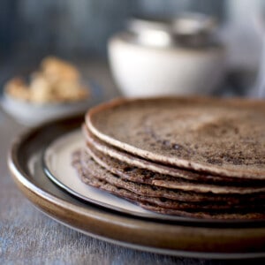 Brown plate with a stack of Sweet Ragi Dosa