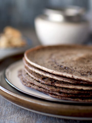 Brown plate with a stack of Sweet Ragi Dosa