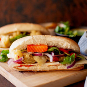 Chopping board with vegetarian hoagie sandwich.