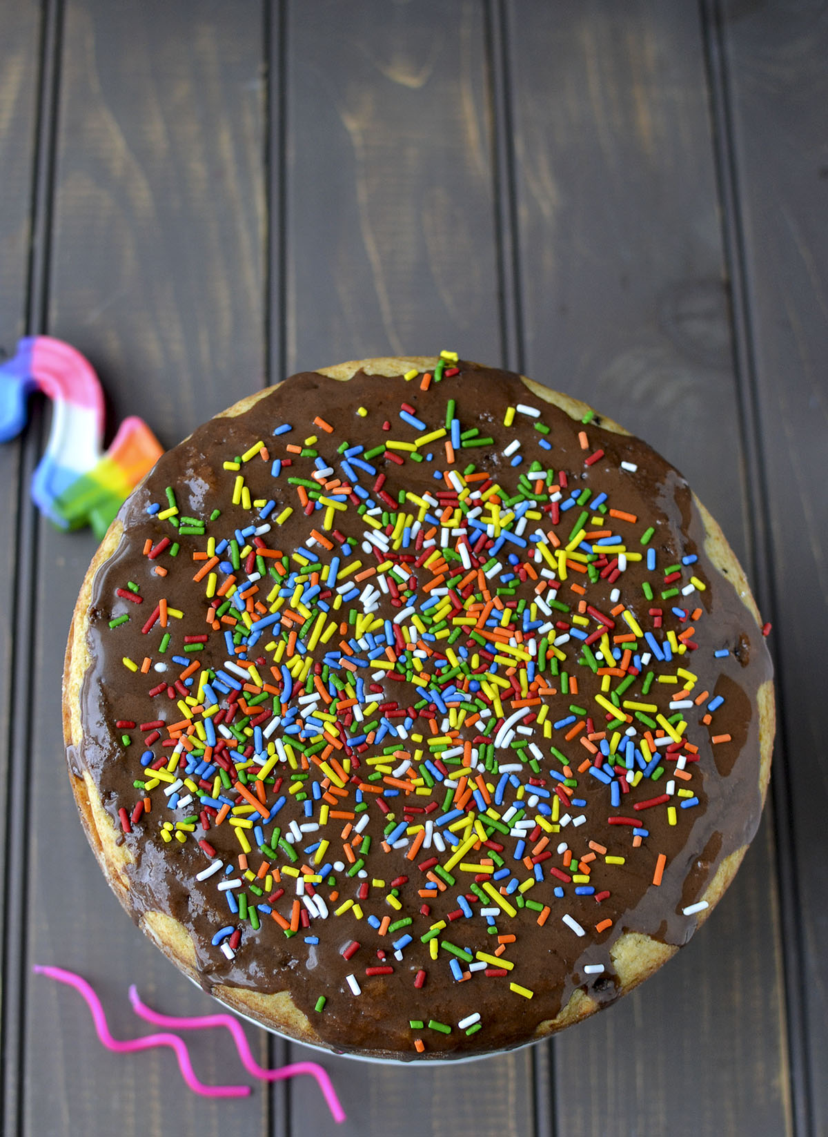 Top view of a cake with chocolate ganache and sprinkles