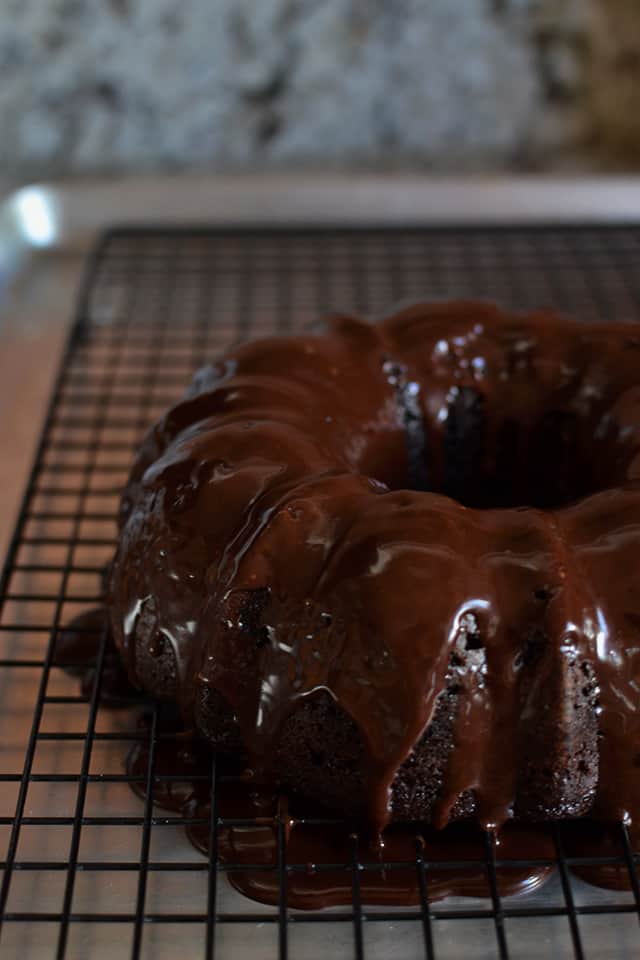 Perfect Chocolate Cake drizzled generously with chocolate icing on a wire rack