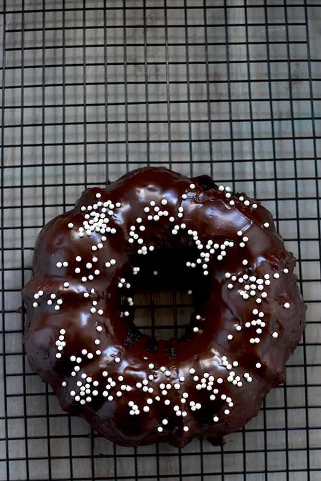 Chocolate Bundt Cake with chocolate glaze and sprinkles on a wire rack 