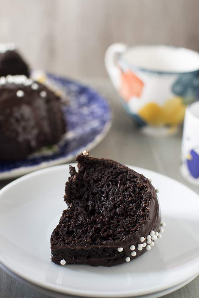 Perfect slice of moist chocolate cake on a white plate