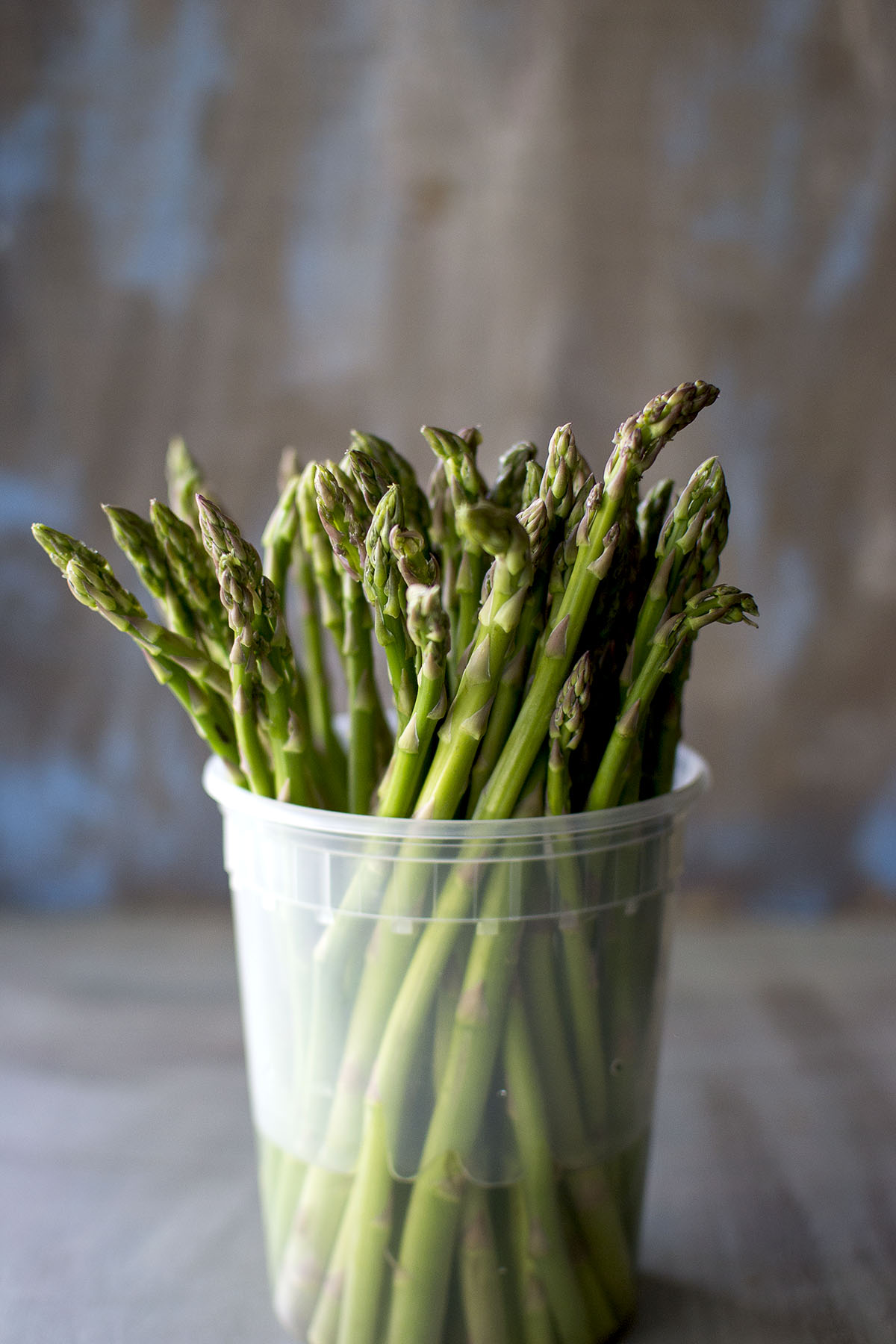 Plastic Container with fresh asparagus