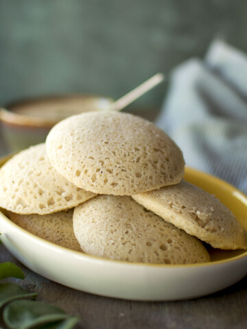 White plate with a stack of jowar idli.