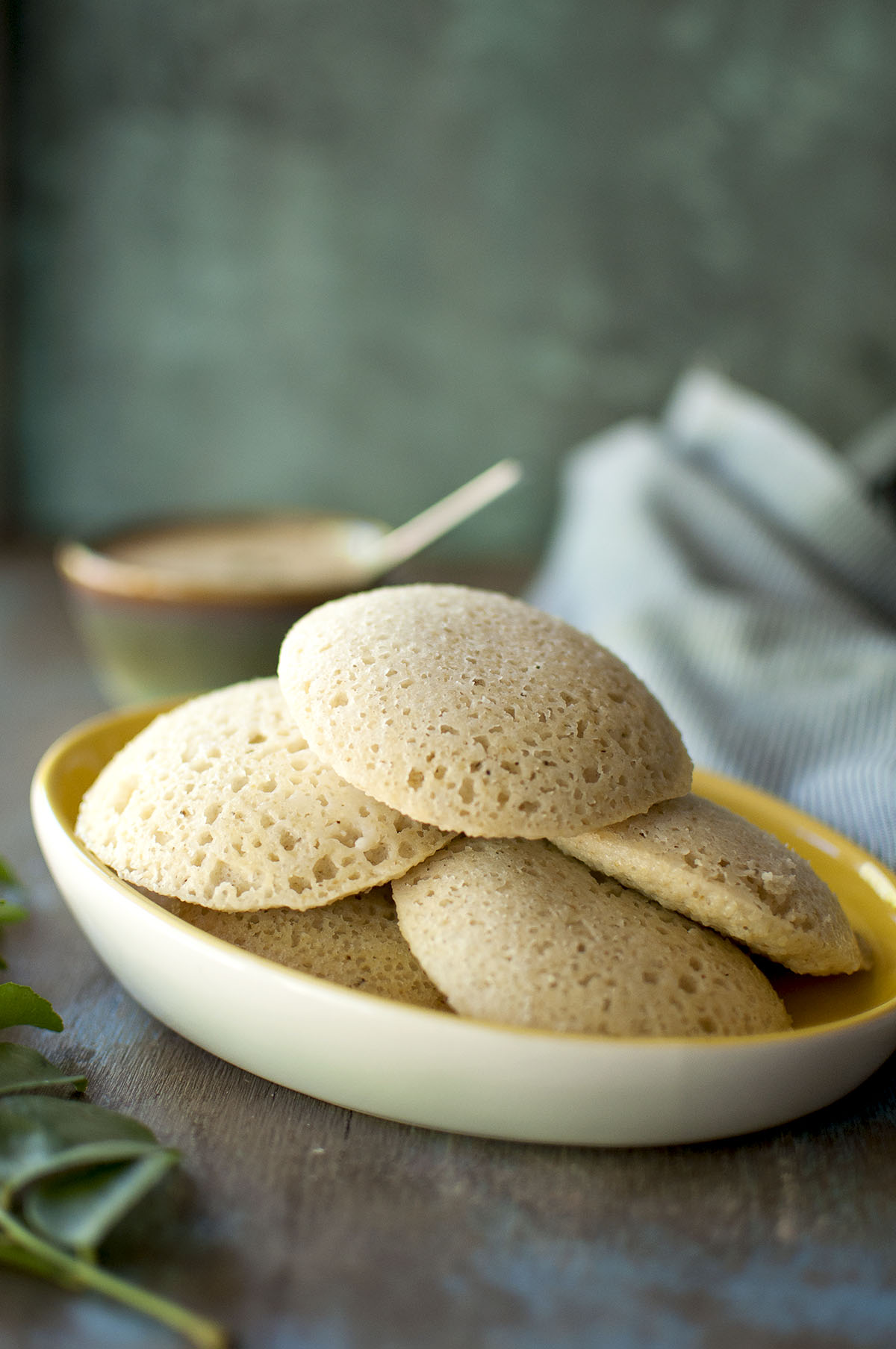 White plate with stack of idli