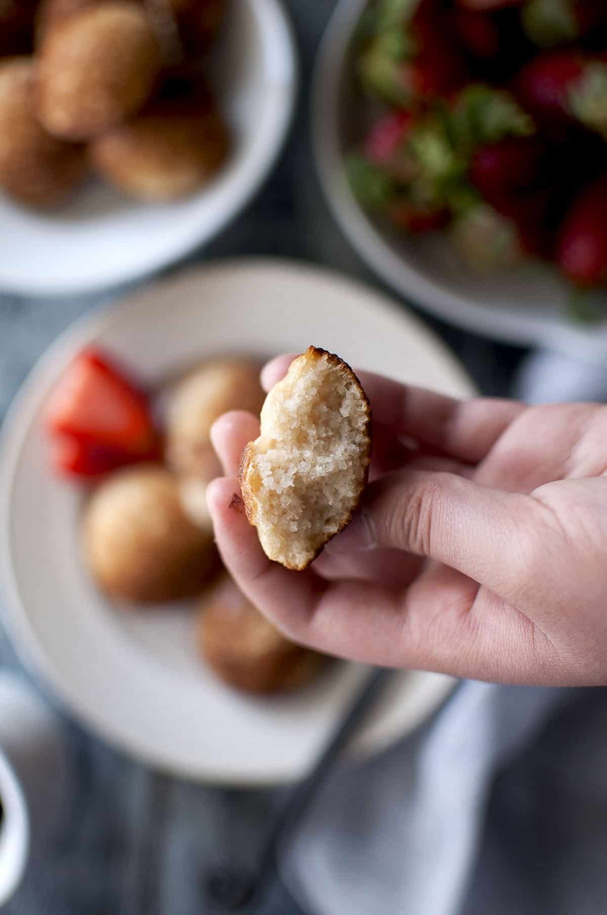 Hand holding half pancake showing the inside