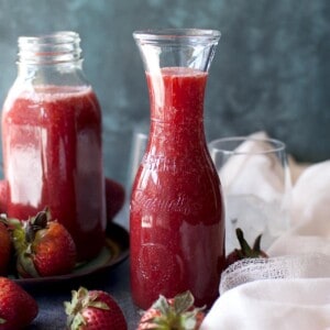 two glass jars with strawberry crush