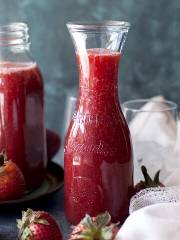 two glass jars with strawberry crush