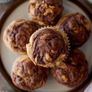 Top view of a white plate with a stack of banana muffins with nutella.
