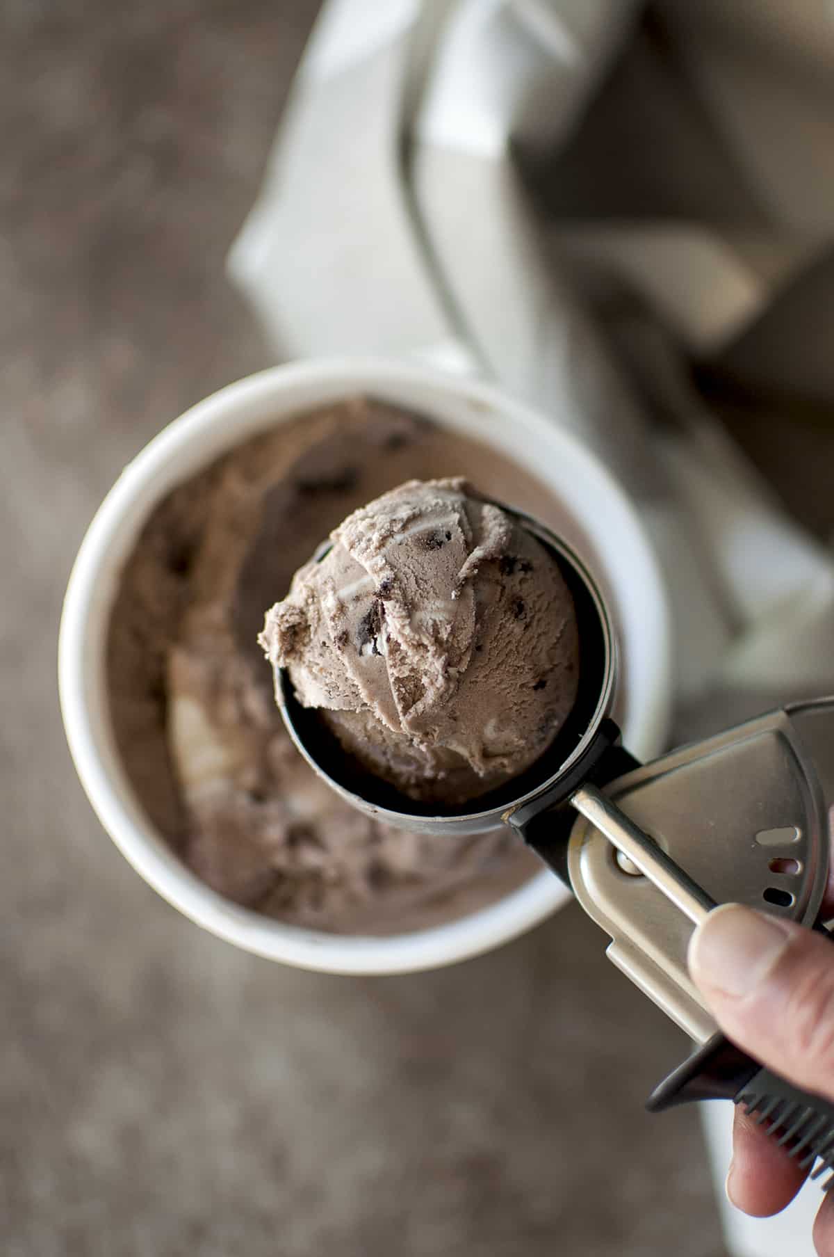 Hand holding a scoop of ice cream