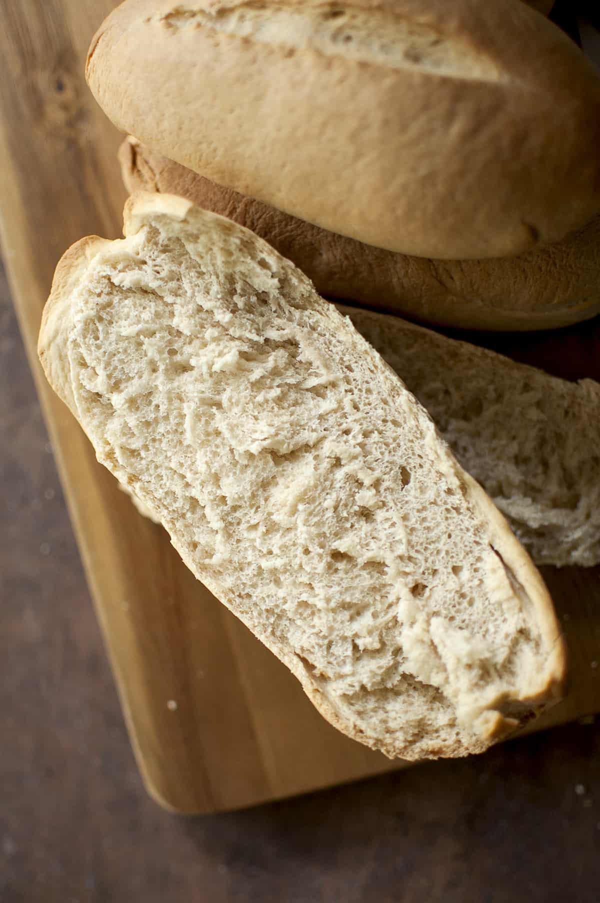 Wooden board topped with halved roll