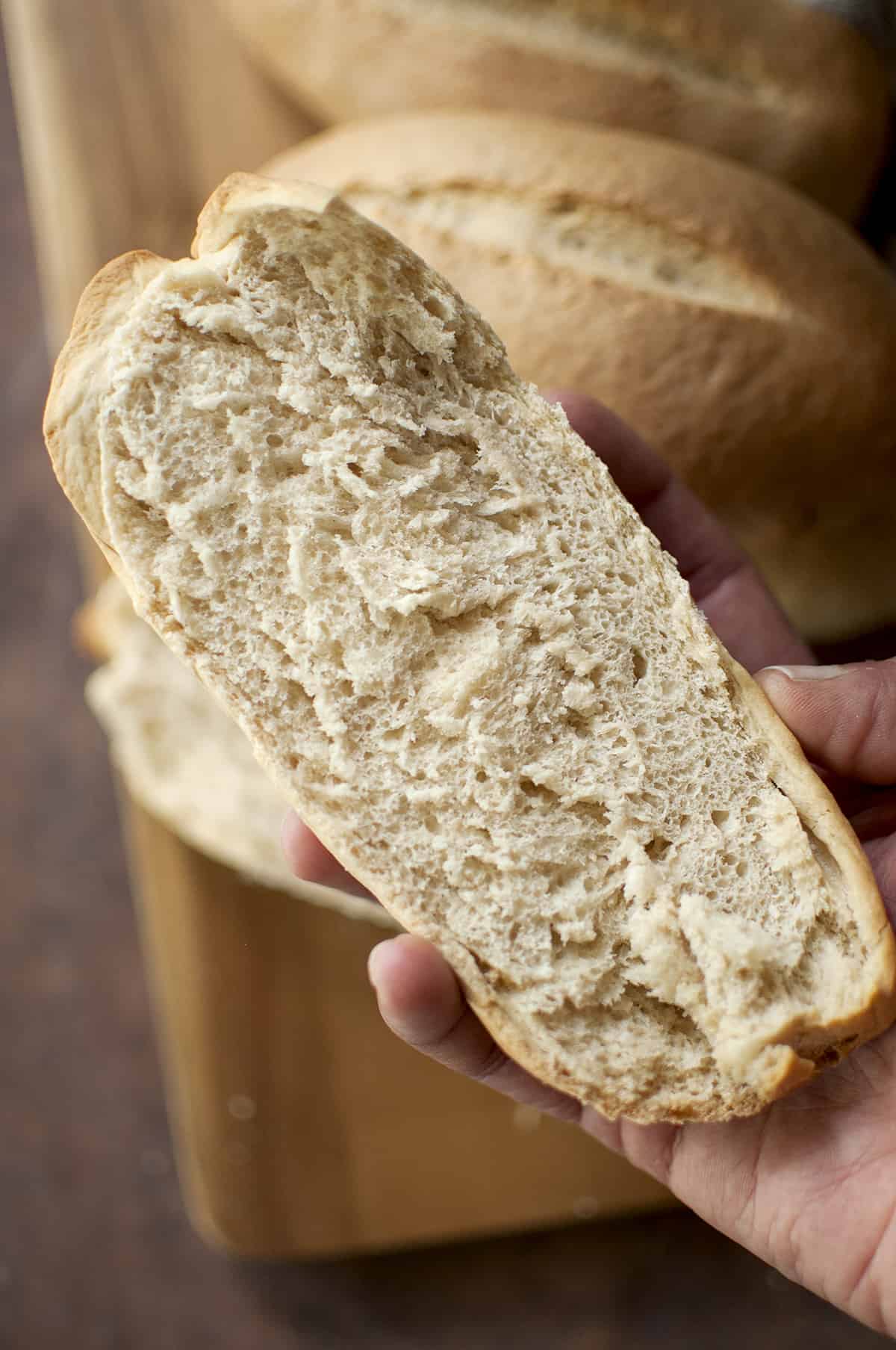 Hand holding split bread