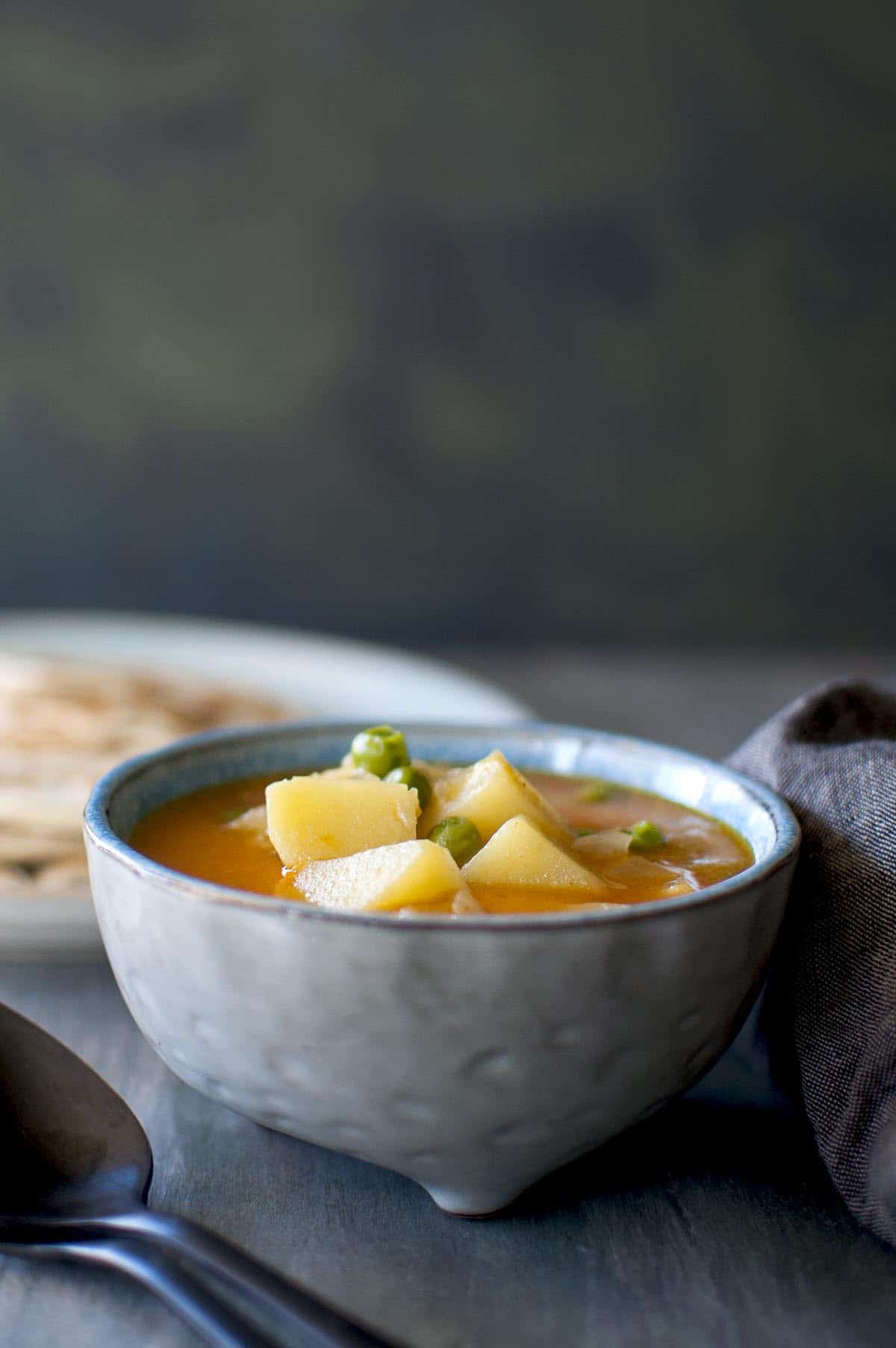 Blue bowl with potato and peascurry