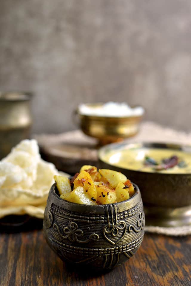 Bowl of Potato Curry with papad and rice