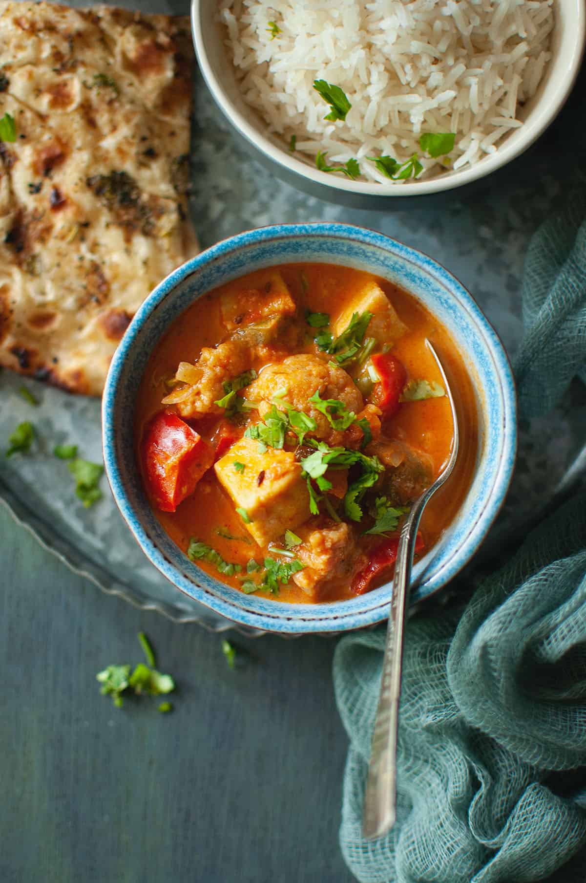 Blue bowl with paneer mix veg curry on a try.