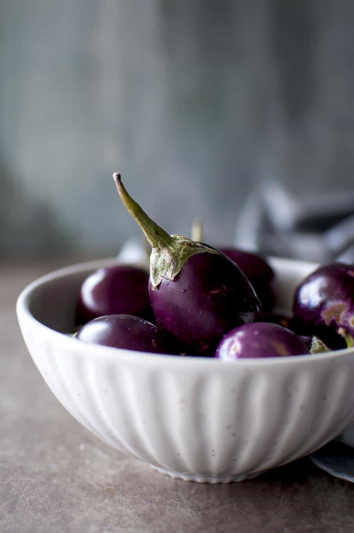 White bowl with baby eggplant