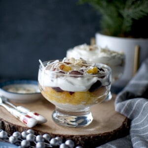 Ambrosia Salad Parfait in a glass set over a wooden board