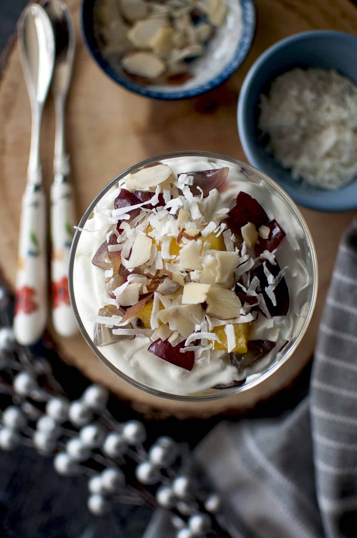 Top view of Ambrosia salad parfait topped with toasted nuts and grated coconut