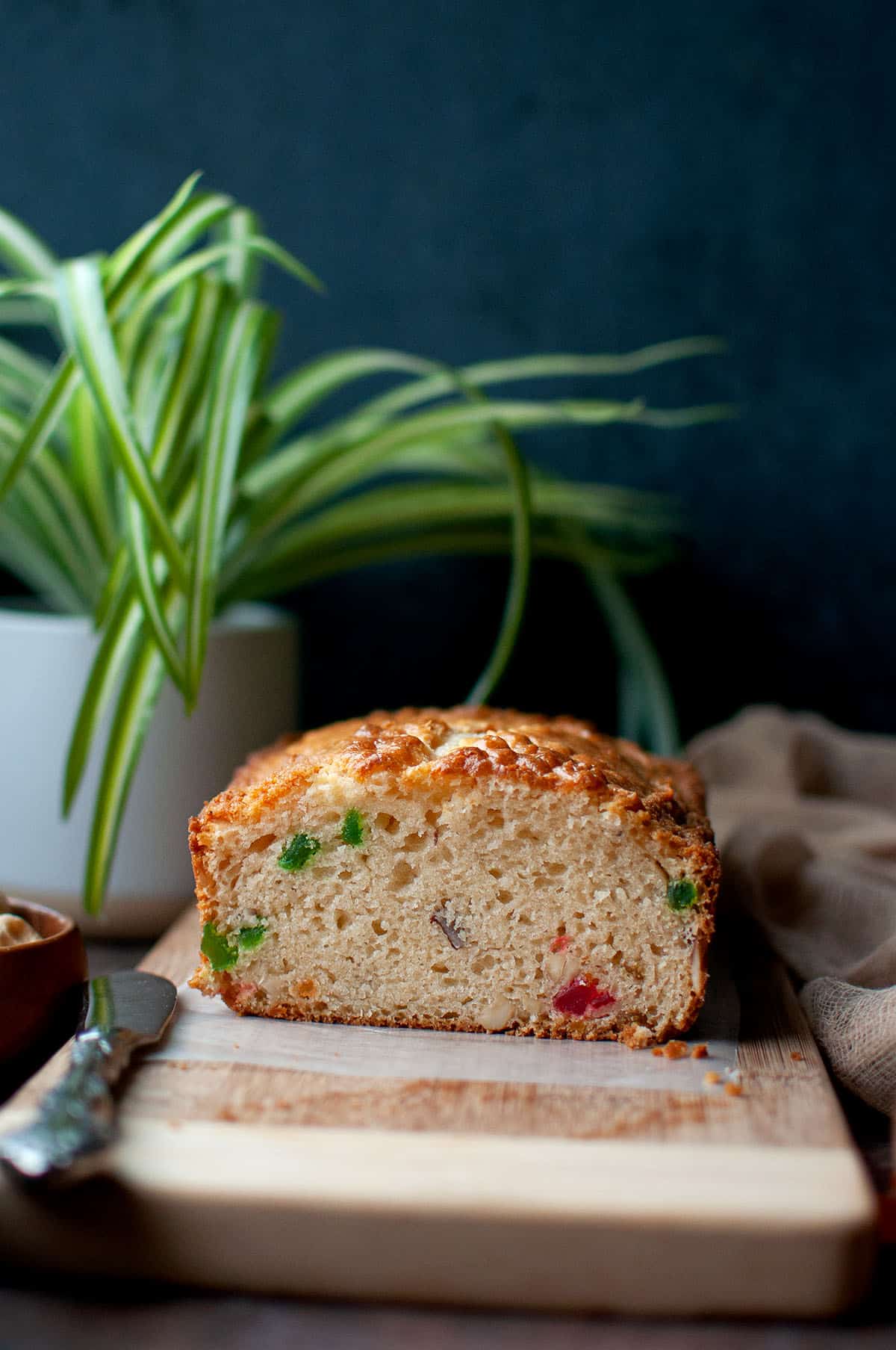 Front view of a cut fruit and nut cake.