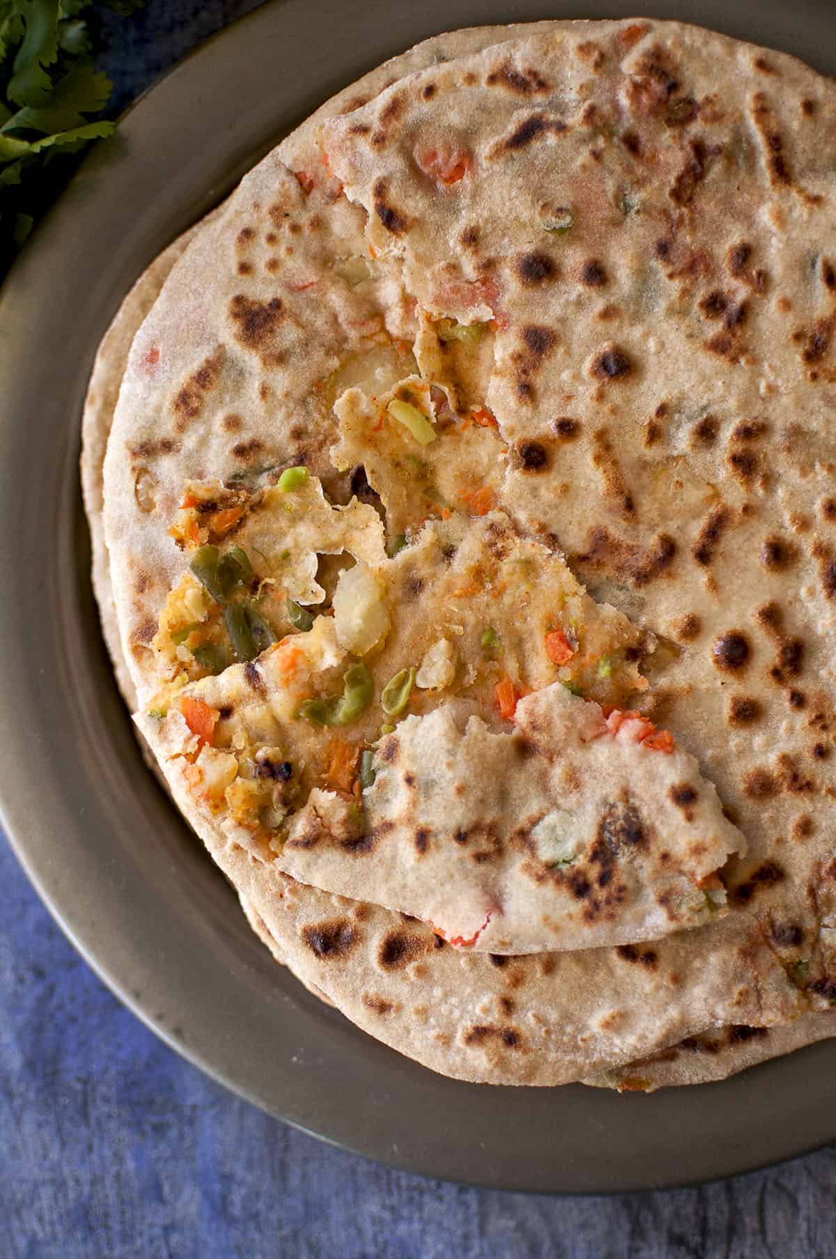 Grey plate with veggie stuffed paratha