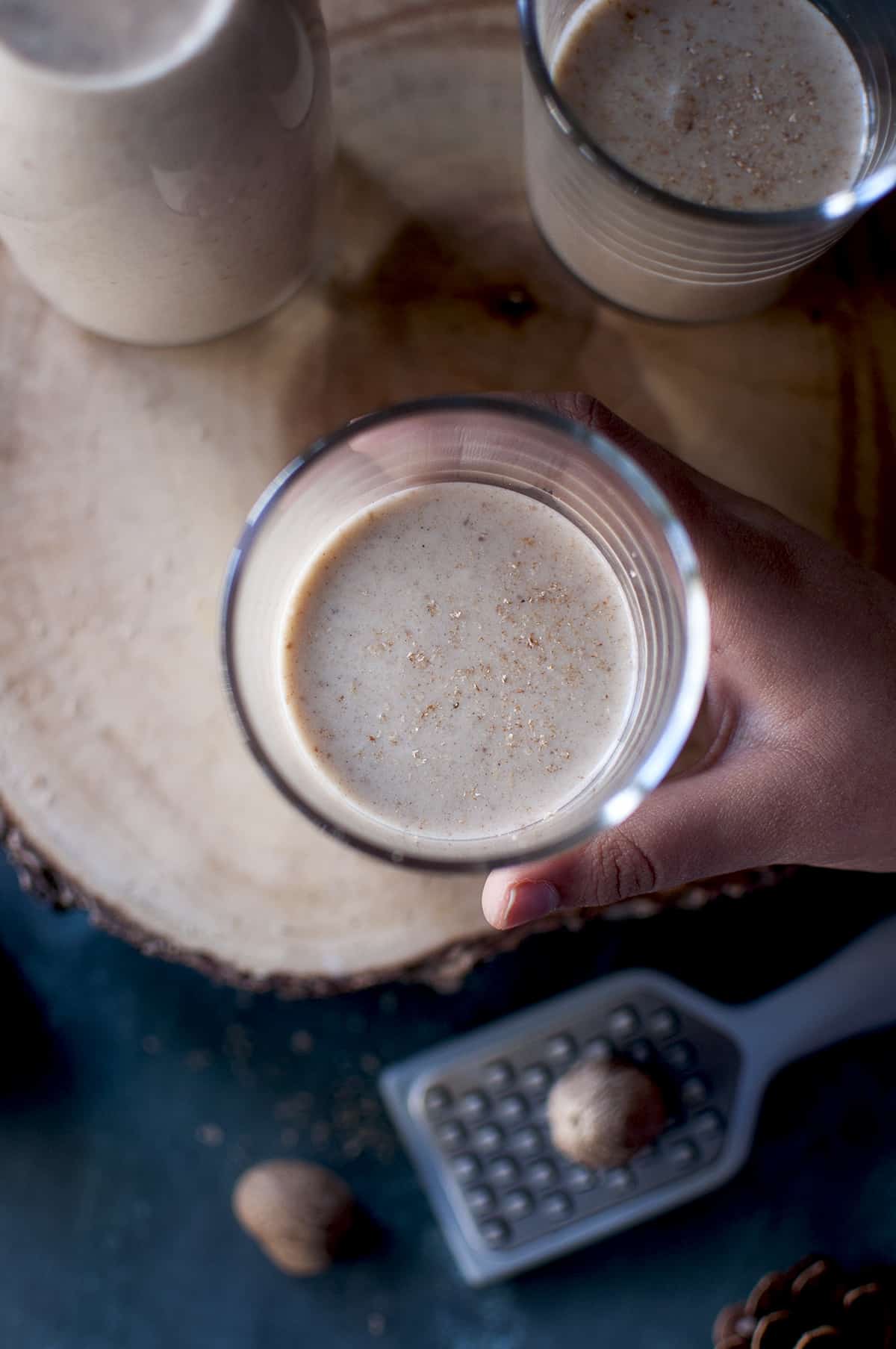 Hand holding a glass of holiday drink