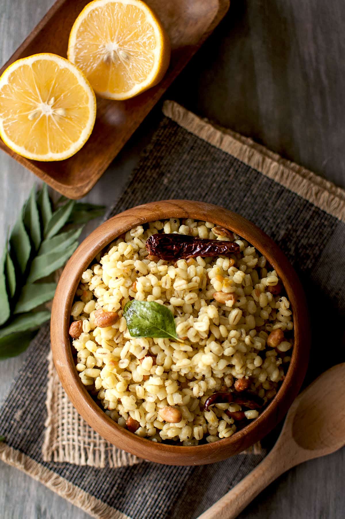 Wooden bowl with citrus flavored whole grains