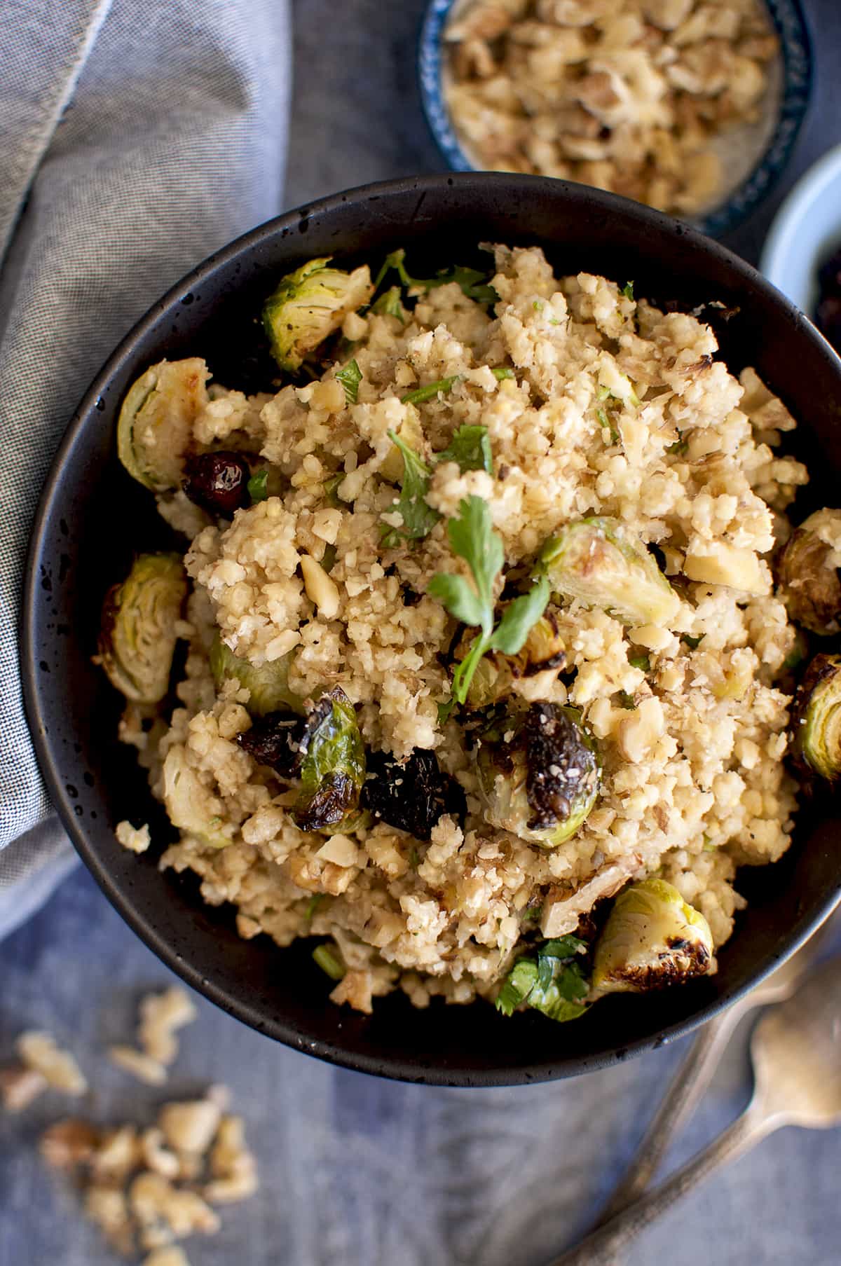 Black bowl with warm millet salad.