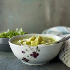 Grey printed bowl with green paneer curry