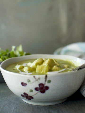 Grey printed bowl with green paneer curry