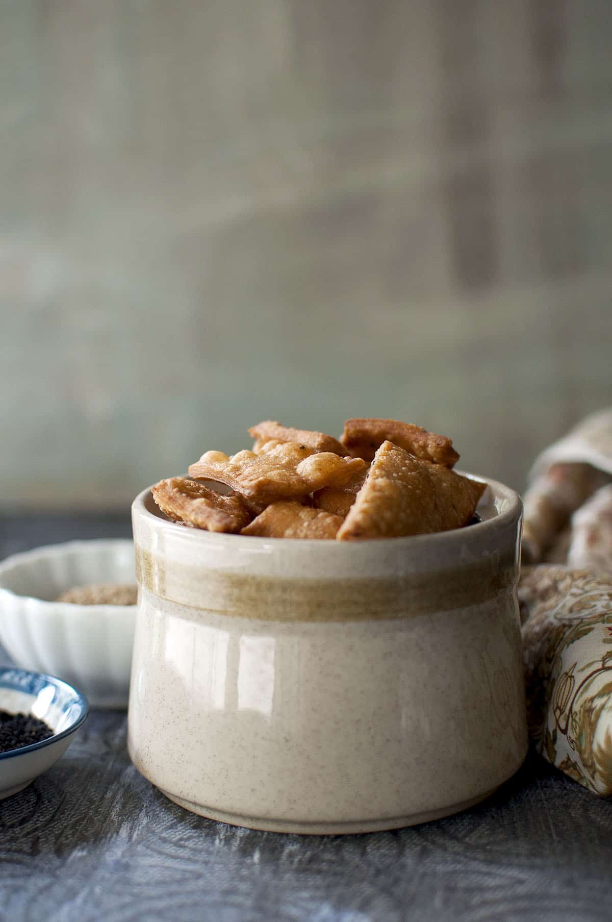 Cream bowl filled with namak pare