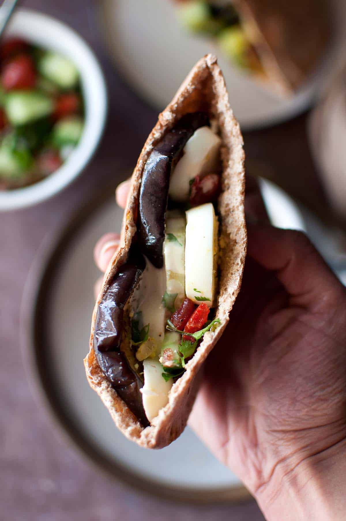 Hand holding an Israeli pita.