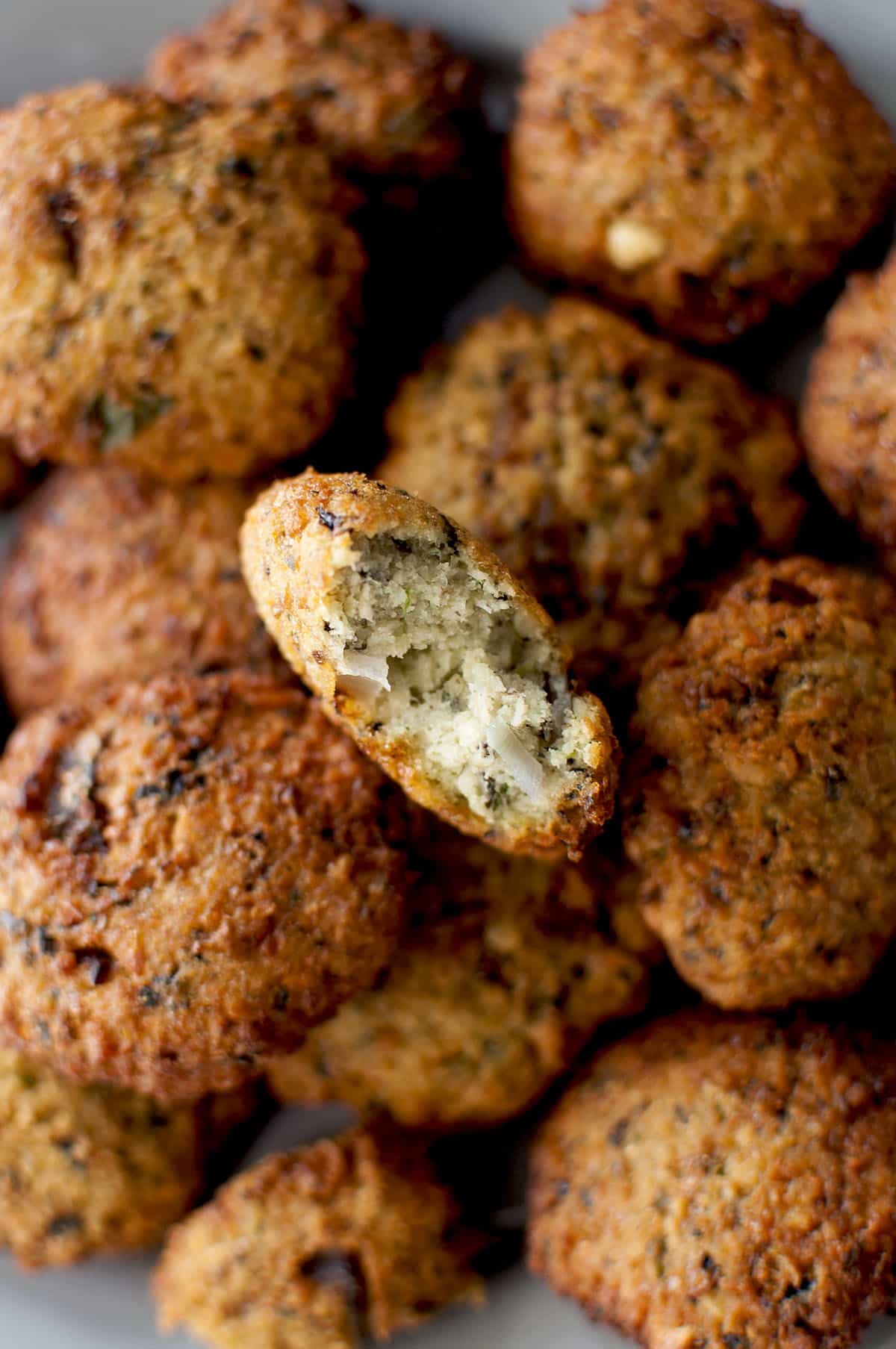 One halved black eyed peas fritter on top of a stack