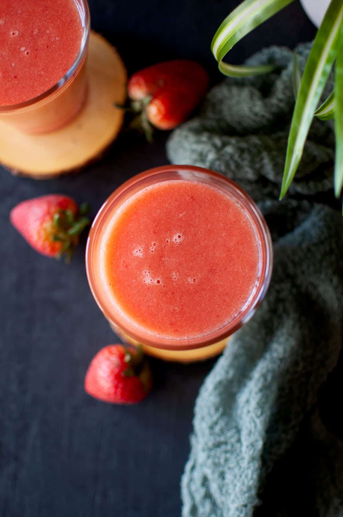 Top view of a glass with strawberry grapefruit smoothie.