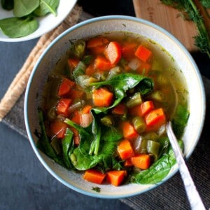 Blue bowl with vegan broth soup.