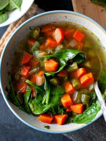 Blue bowl with vegan broth soup.