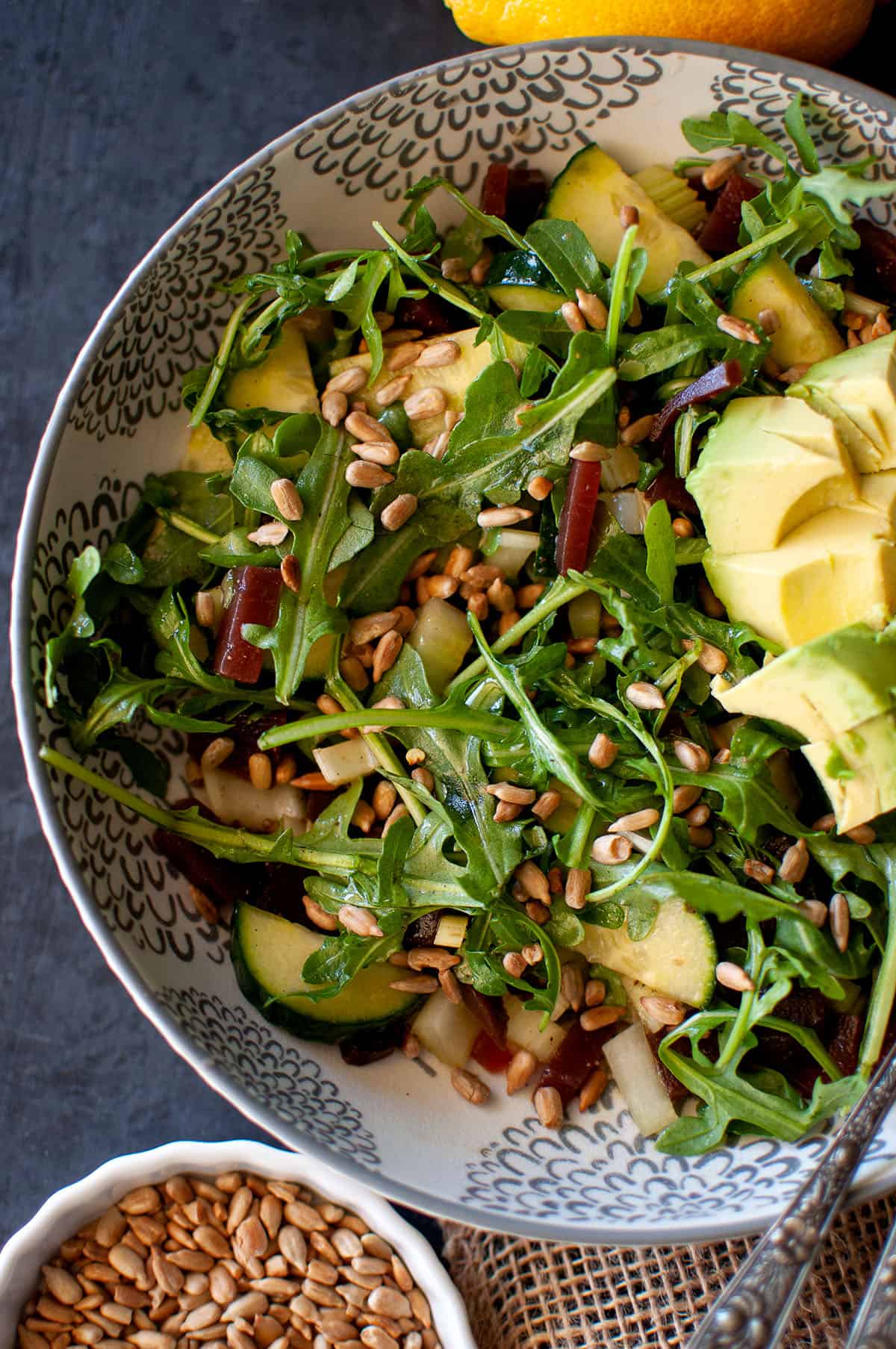 White bowl with beet and arugula salad.