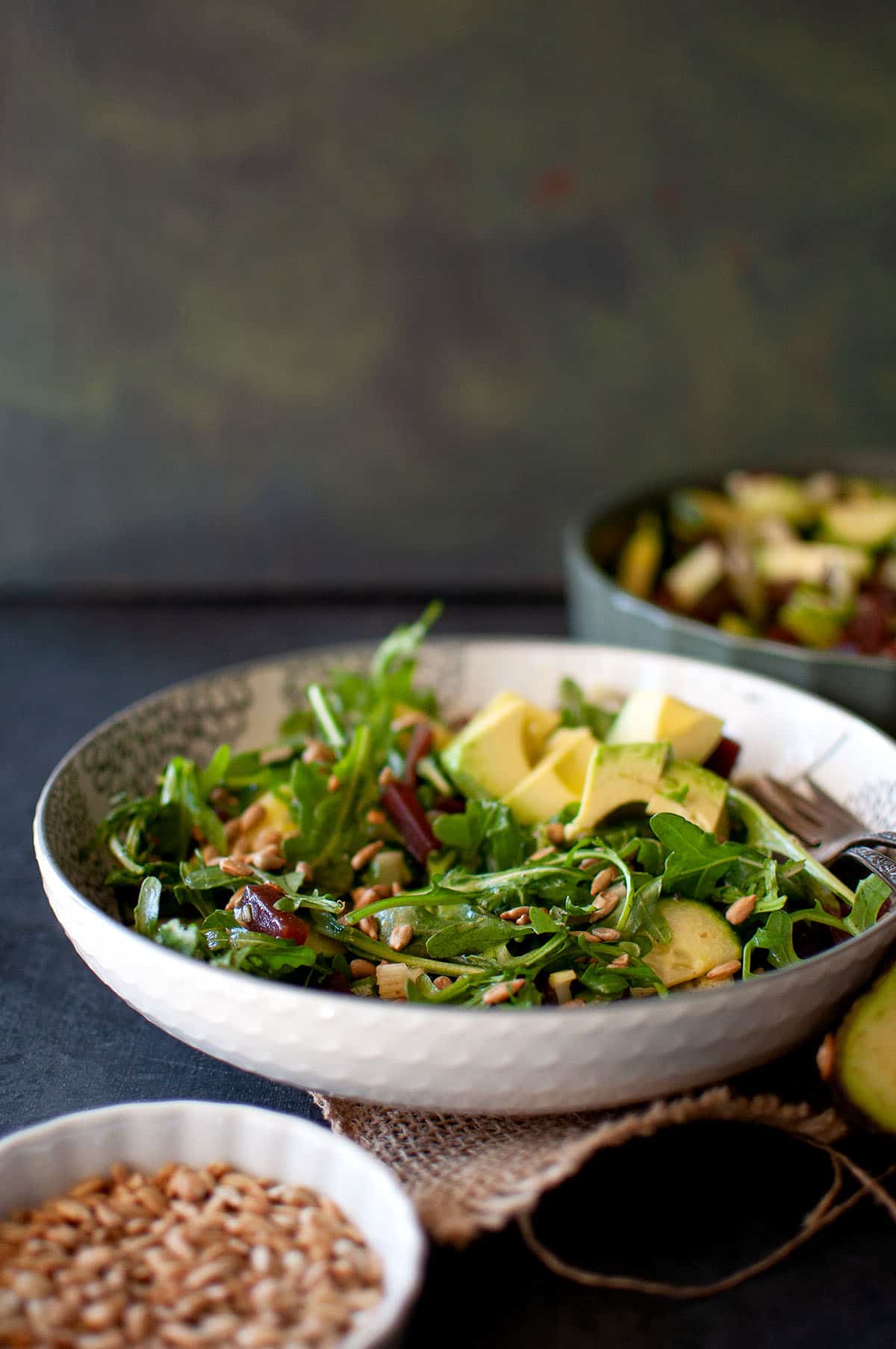 White bowl with beetroot salad with arugula.