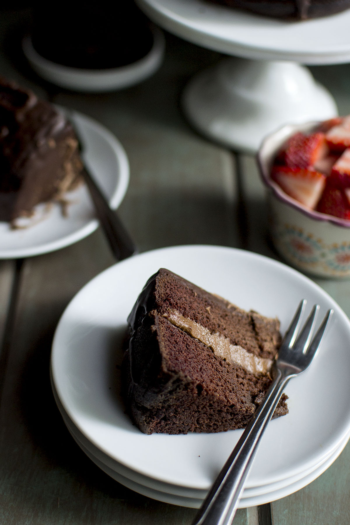 White plate with a slice of chocolate cake