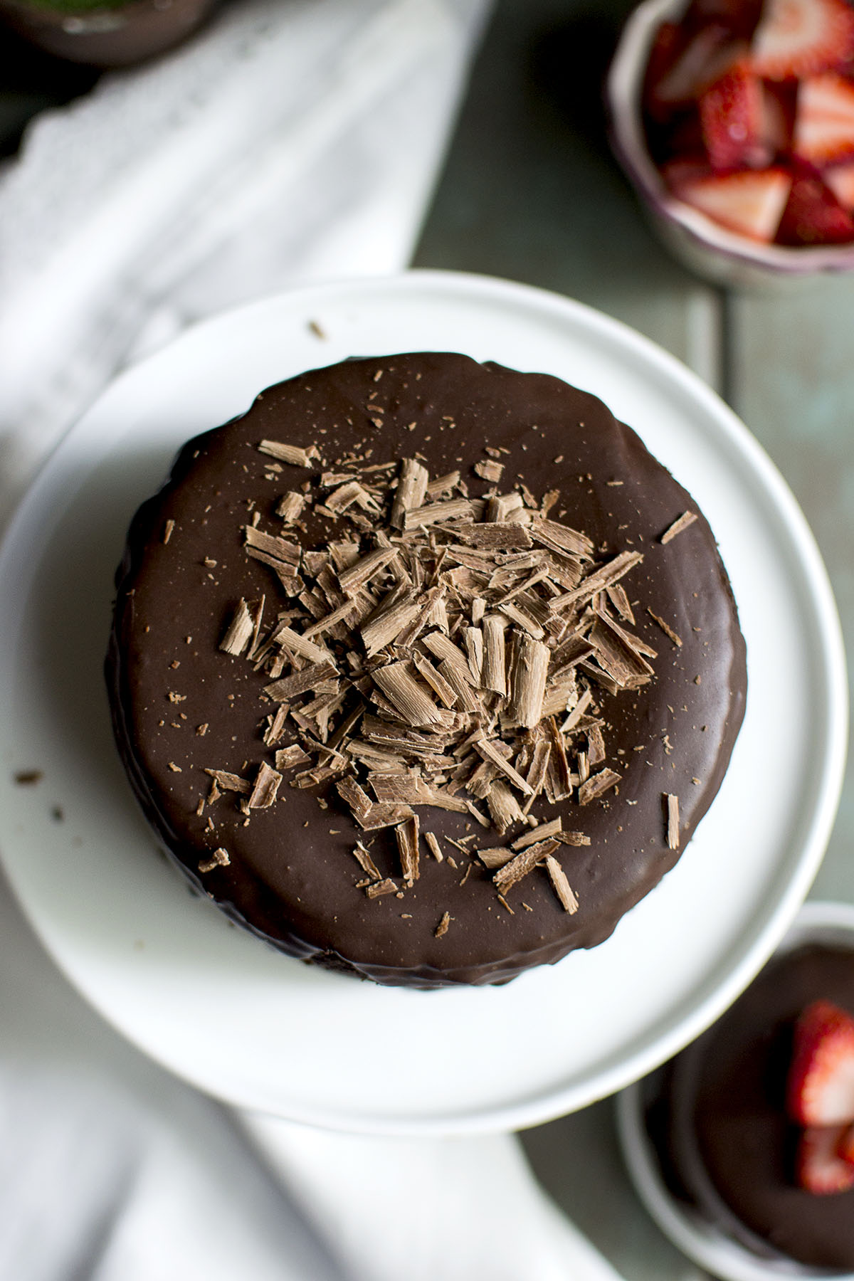 White plate with chocolate cake with shaved chocolate on top