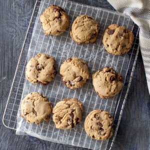 Wire rack covered with parchment paper with 9 cookies